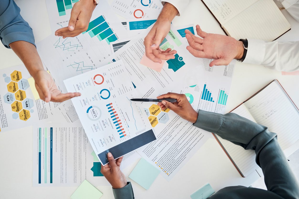 digital-marketing-hands-and-data-analysis-meeting-for-financial-reports-and-branding-for-a-startup-company-paperwork-charts-and-business-people-planning-a-global-seo-promotional-campaign-project