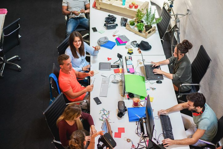 young-people-working-inside-marketing-agency-office-business-and-startup-concept-focus-on-man-face-wearing-orange-t-shirt